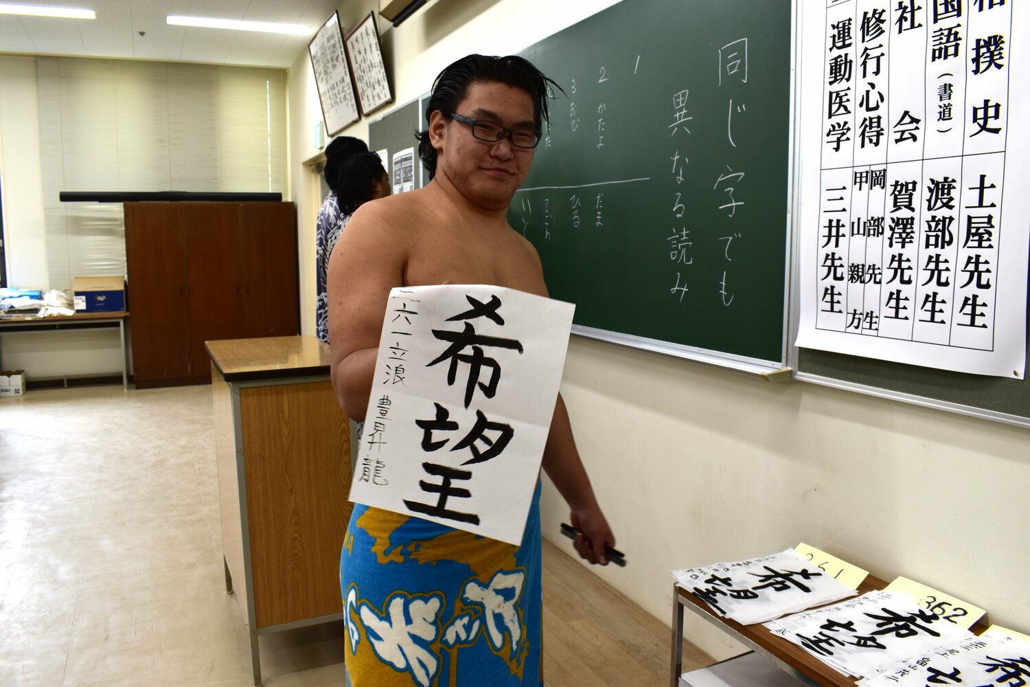 相撲教習所で自ら書いた「希望」を手に微笑む豊昇龍　©Saki Iizuka