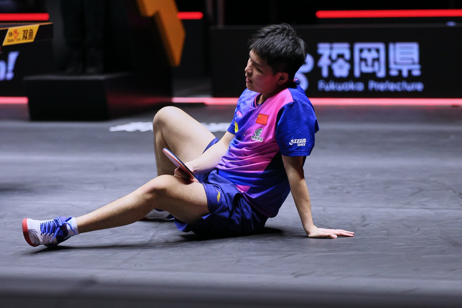 張本の攻めに倒れ込む林 ©Getty Images