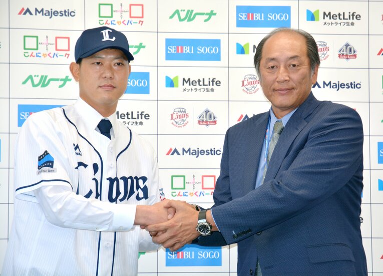 西武入団時、渡辺久信SDと握手する内海　©JIJI PRESS