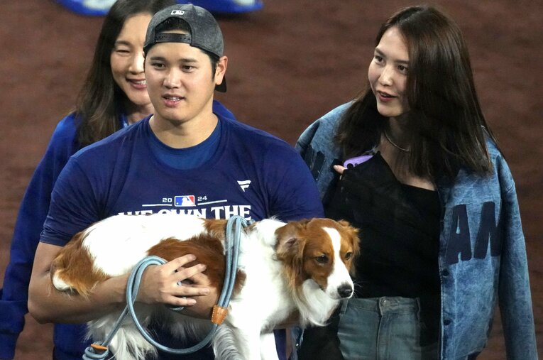 デコピンを抱く大谷翔平と妻の真美子さん（2024年） ／ photograph by JIJI PRESS