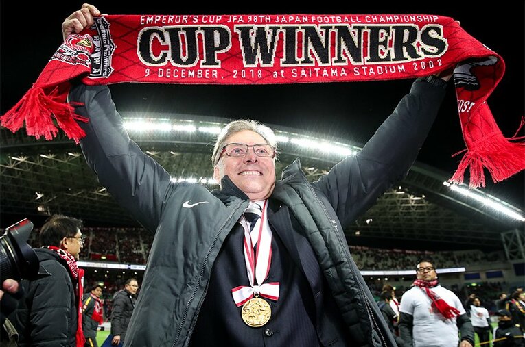 昨年の天皇杯優勝後、スタンドに向けてタオルマフラーを掲げるオリヴェイラ監督。その一挙手一投足がサポーターの心を掴んでいる。 ／ photograph by Getty Images