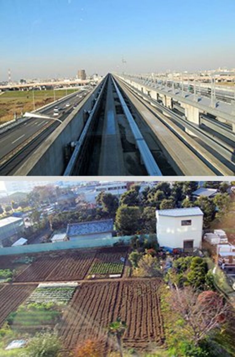 通常の鉄道と違って鉄のレールが無い新交通システムの路面。車窓風景は……高層ビルの無い風景がどこまでも広がる感じである。見え隠れする畑は、ここが都内ということを忘れさせる趣アリ