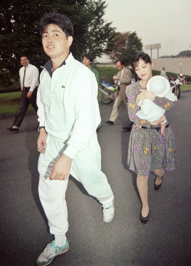 1991年撮影。日本シリーズ第1戦で完投勝利を挙げた工藤は、夫人の雅子さんと長男と一緒に球場を引き上げる ©Sankei Shimbun
