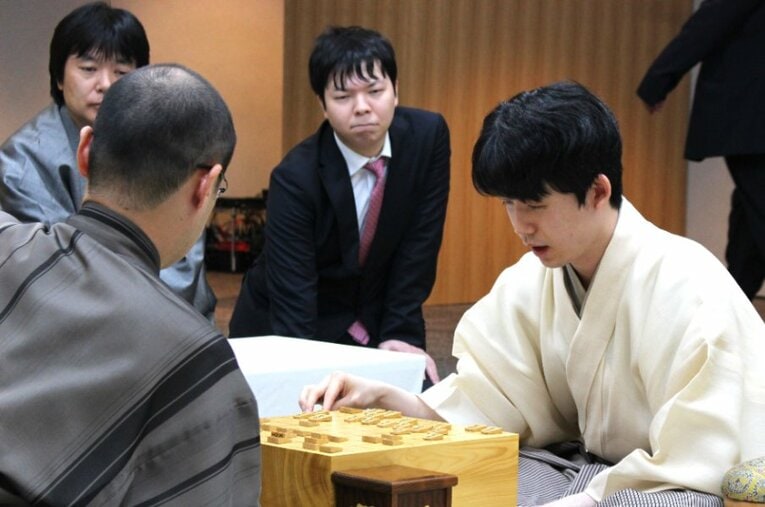 藤井聡太王位と渡辺明九段による王位戦第1局は千日手指し直しに。感想戦を見守る立会人の藤井猛九段と副立会人の高見泰地七段 ／ photograph by Number Web