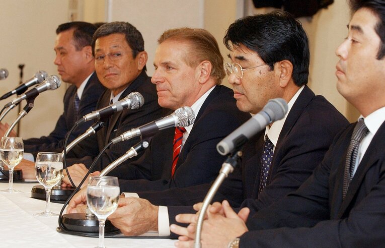 2004年11月、オリックスと楽天の分配ドラフトを終え、記者会見に臨む両チーム首脳。中央は楽天のマーティ・キーナートGM、その右隣が広野。左隣はオリックスの仰木彬監督　©JIJI PRESS