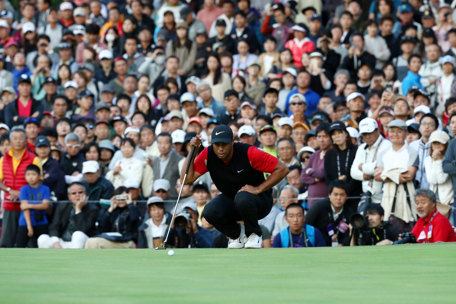 ギャラリーに囲まれながらパットに集中するタイガー・ウッズ(2019年)©︎Getty Images
