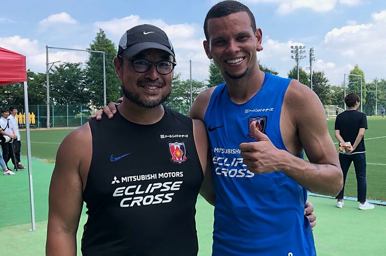 エヴェルトン（右）と肩を組む羽生通訳。現在は浦和でブラジル人選手のサポートを担当している。 ／ photograph by Masayuki Sugizono