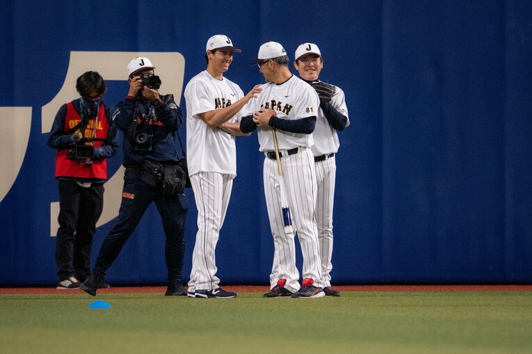吉井コーチと互いに腕を触わり合う大谷　©︎Nanae Suzuki