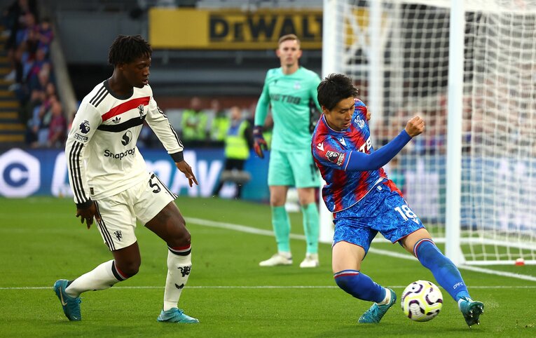 9月21日のマンチェスター戦、MFコビー・メイヌー（19歳）と競り合う鎌田　©Getty Images