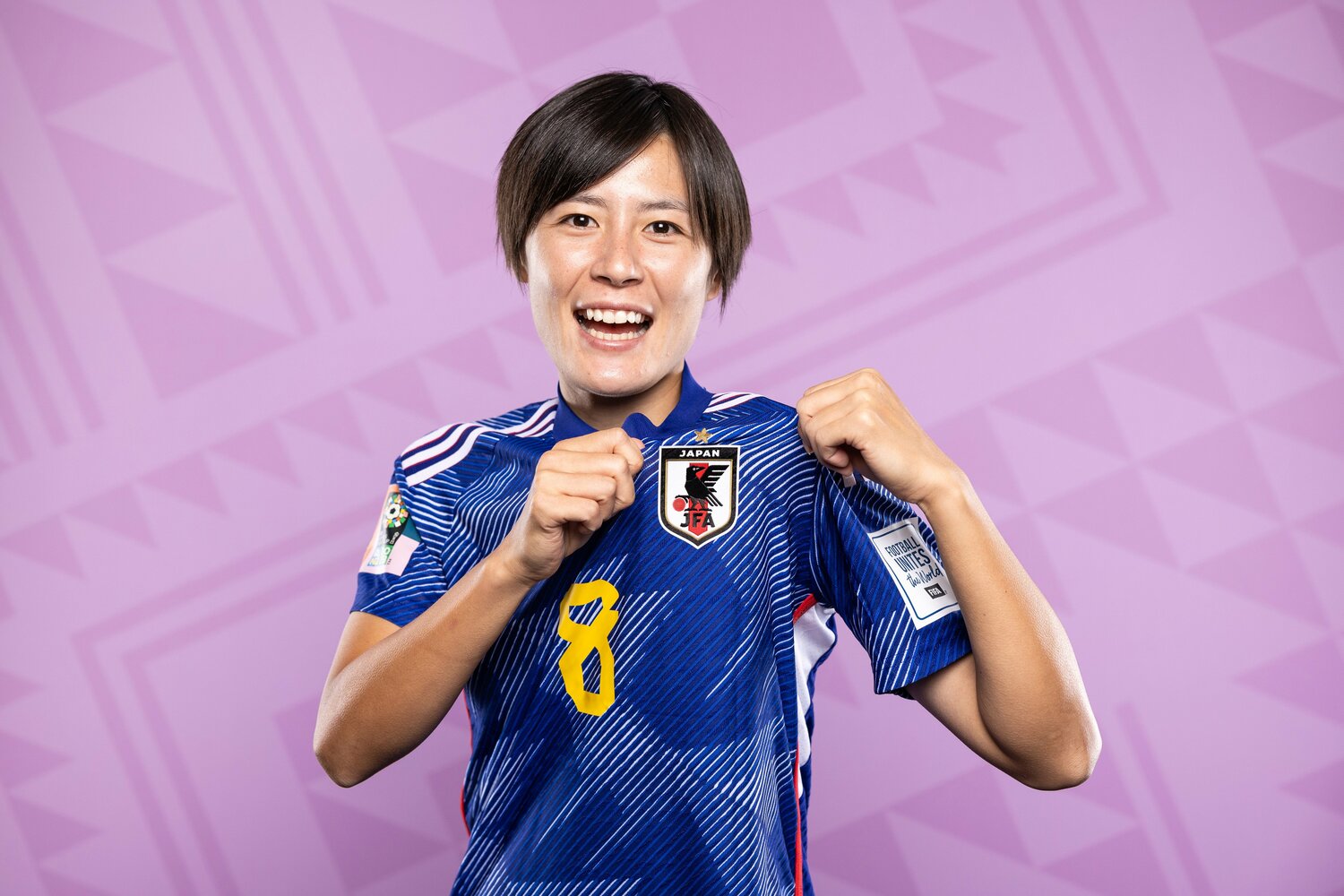 FIFAの公式撮影で日本サッカーのエンブレムを強調する猶本光　©︎Getty Images