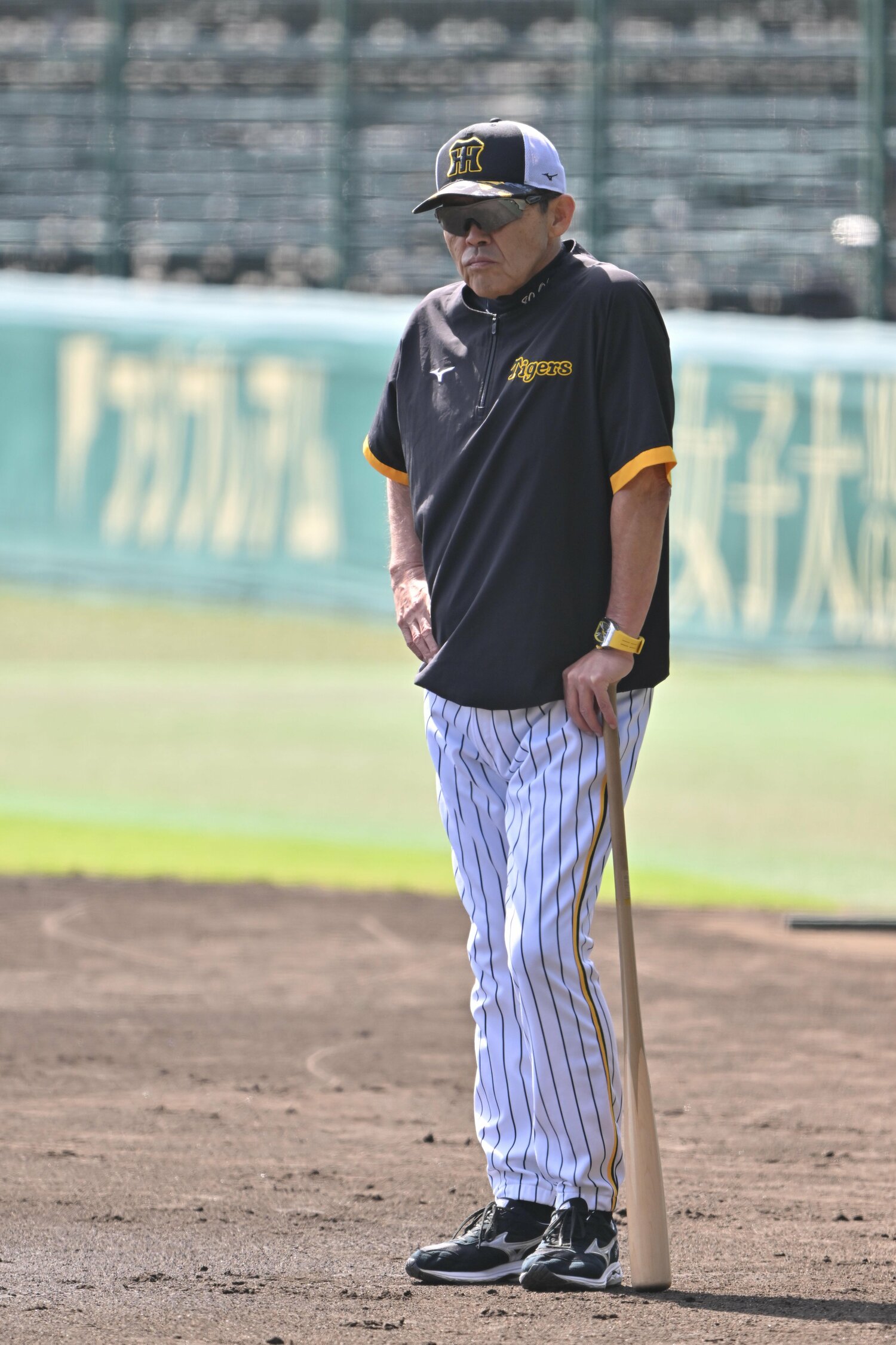 2024年のCSファーストステージ前日、バットを杖代わりにしてグラウンドに立つ岡田彰布 ©JIJI PRESS