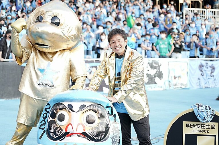 2年連続のJ1優勝を決め、ふろん太くんに渡された金色のジャケットを着た鬼木監督 ／ photograph by Getty Images