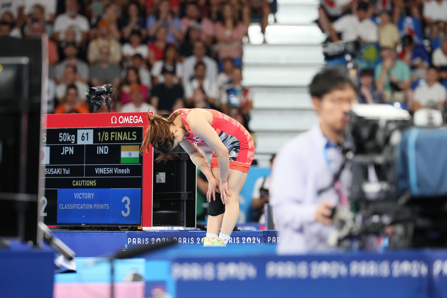 「2対3」というスコアが表示された掲示板の横でうなだれる須崎優衣　©Kaoru Watanabe/JMPA