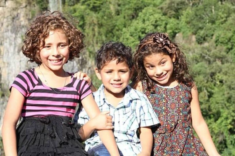 孤児院から引き取られた後の3きょうだいの写真。真ん中が弟のカルロス、一番右が妹のタリア　写真は両親提供