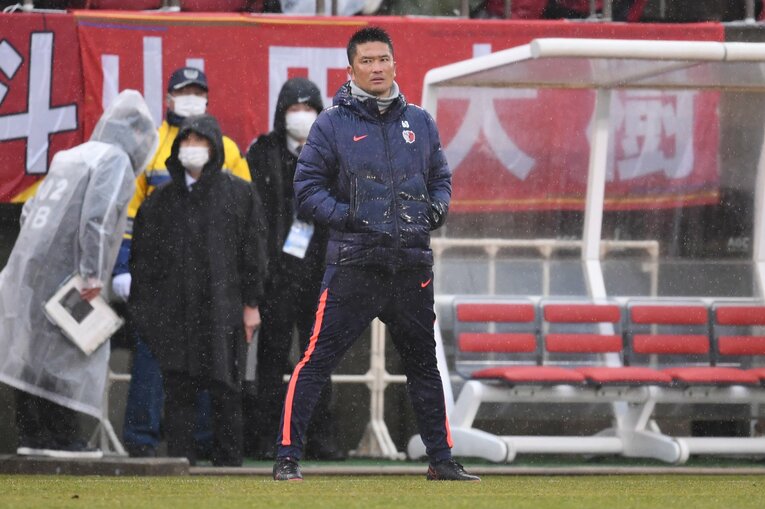 冷たい雨が降るなか、水戸ホーリーホック戦で指揮をとる岩政コーチ　©Getty Images