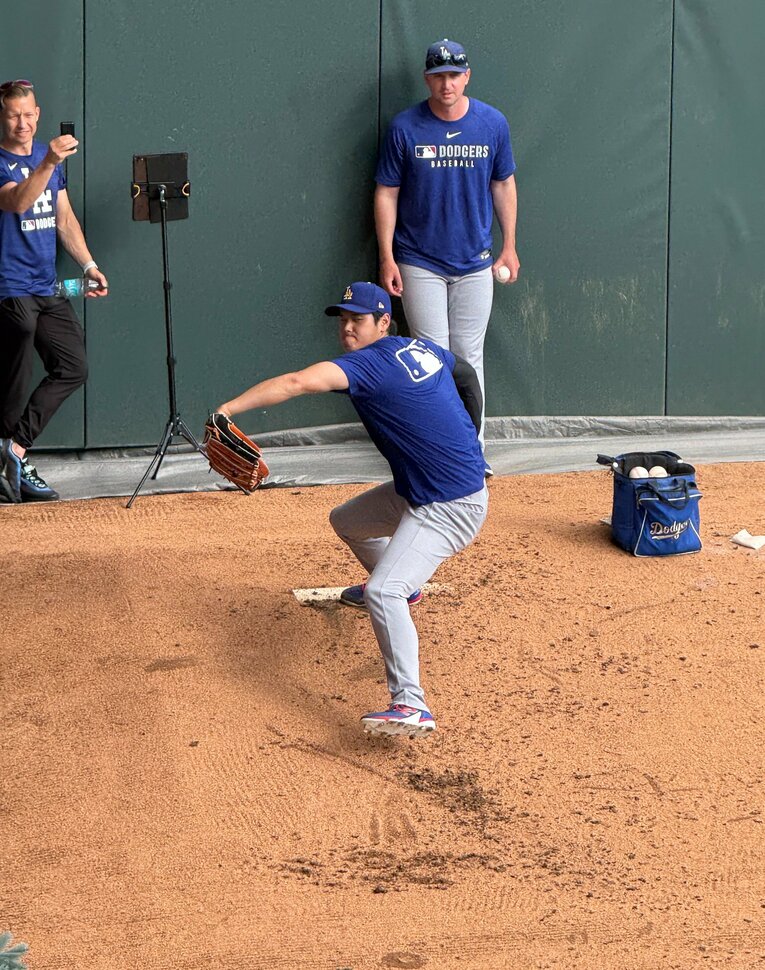 【番記者が撮った“テレビに映らない”大谷＆ドジャース写真】大谷の投球練習。後ろに立つのがマクギネス氏　©Naoyuki Yanagihara