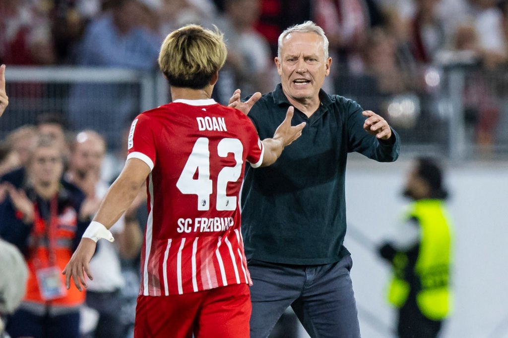 堂安を迎え入れるシュトライヒ監督　©Getty Images