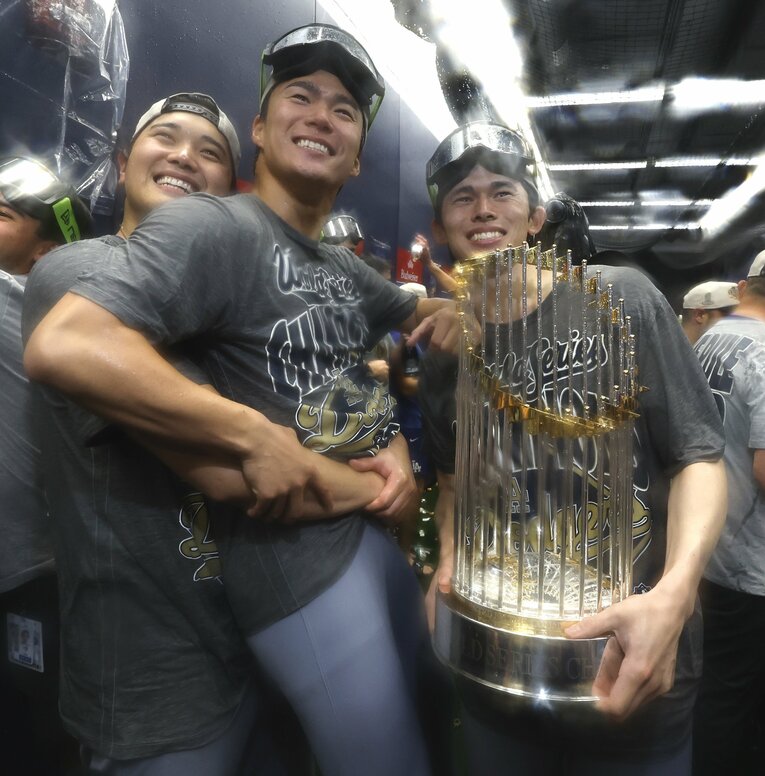 優勝トロフィーを手にシャンパンファイトで笑顔を見せる佐々木朗希、山本、大谷　©JIJI PRESS