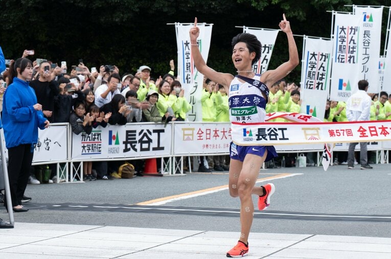 「山川」コールのなか、トップで伊勢路のゴールテープを切った駒澤大の主将、山川拓馬　©Tadashi Hosoda