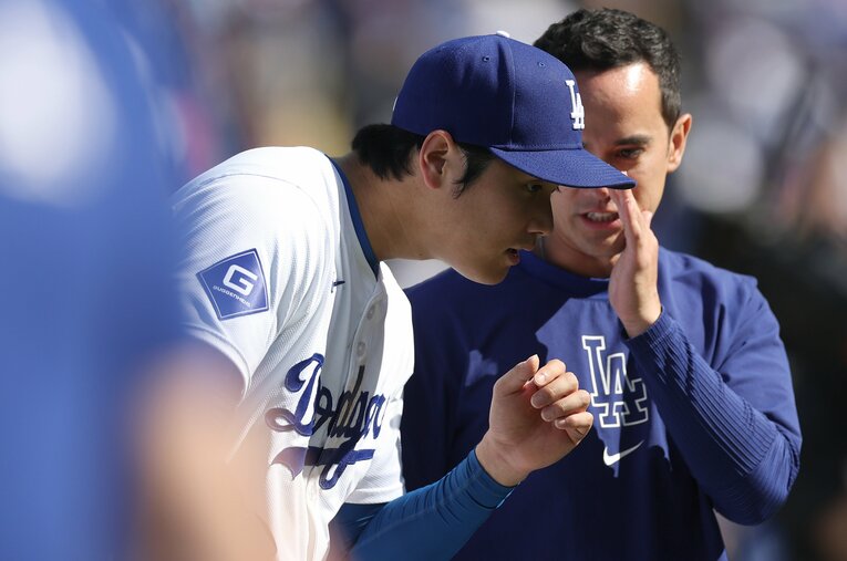 ウィル・アイアトン通訳（右）を言葉をかわす大谷翔平。メッツ右腕ロペスの失言と戦力外通告は、異国の地で生活する人たちにとっては他人事ではなかった ／ photograph by Getty Images