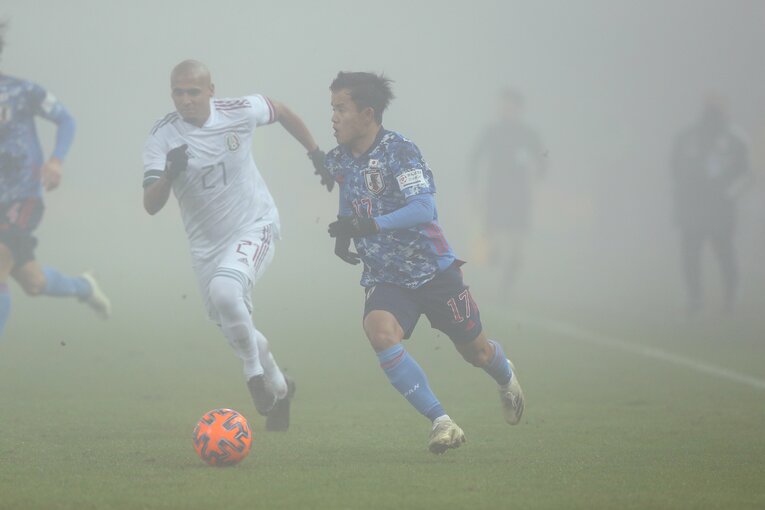 濃霧に覆われたピッチを駆ける久保建英　©JFA