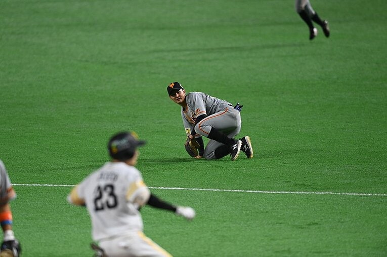 悪送球をして茫然とする巨人・吉川尚。手前は二塁に向かおうとするソフトバンク・周東 ／ photograph by Naoya Sanuki