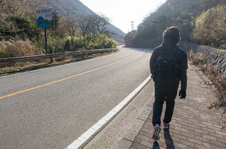 小田原中継所をスタートして約5時間、箱根駅伝5区の国道1号最高地点に到達。“スポット参戦”したカメラマンが筆者の疲弊した背中を撮影 ／ photograph by Shiro Miyake