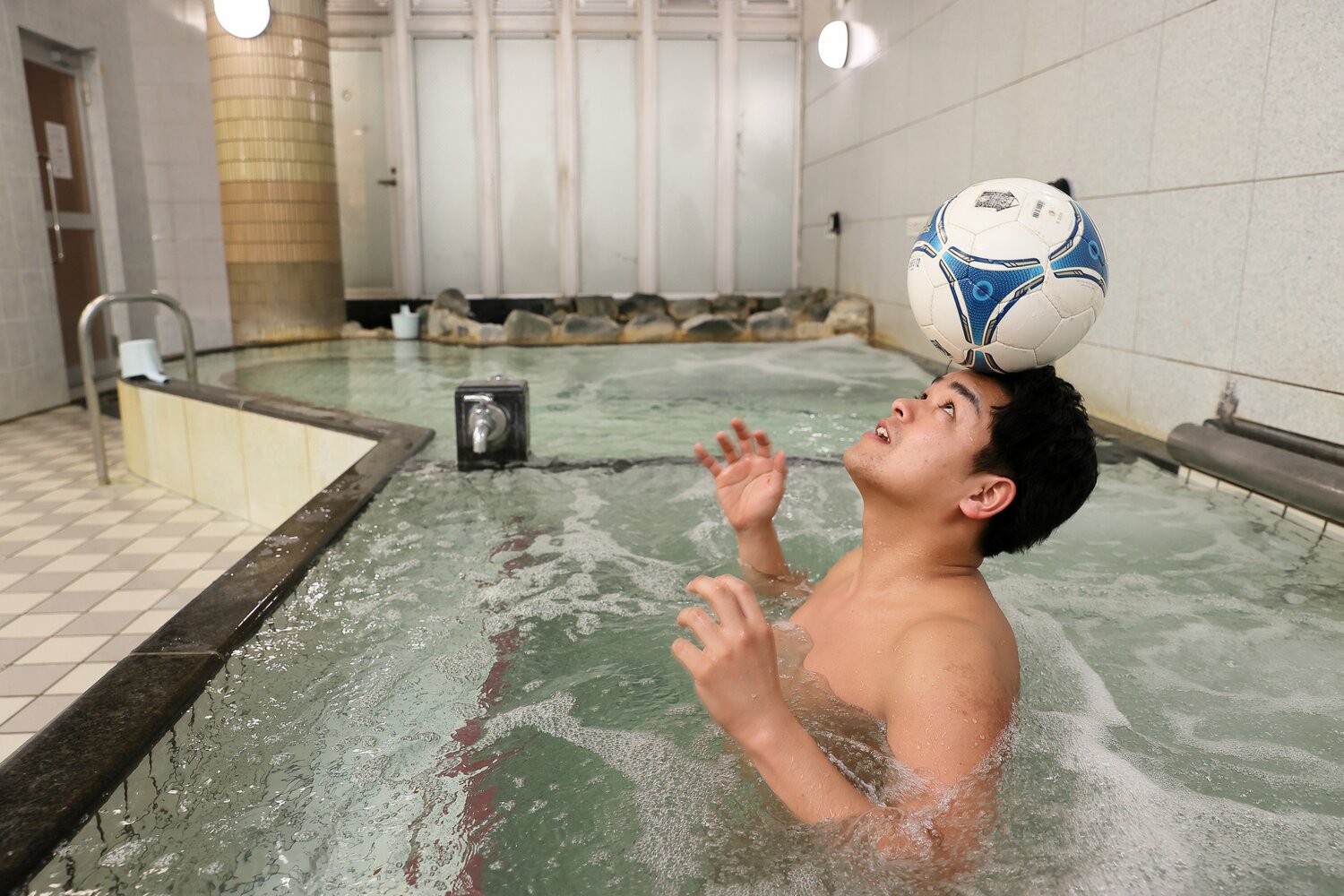 湯船ではサッカーボールと戯れるシーンも　©︎Shigeki Yamamoto