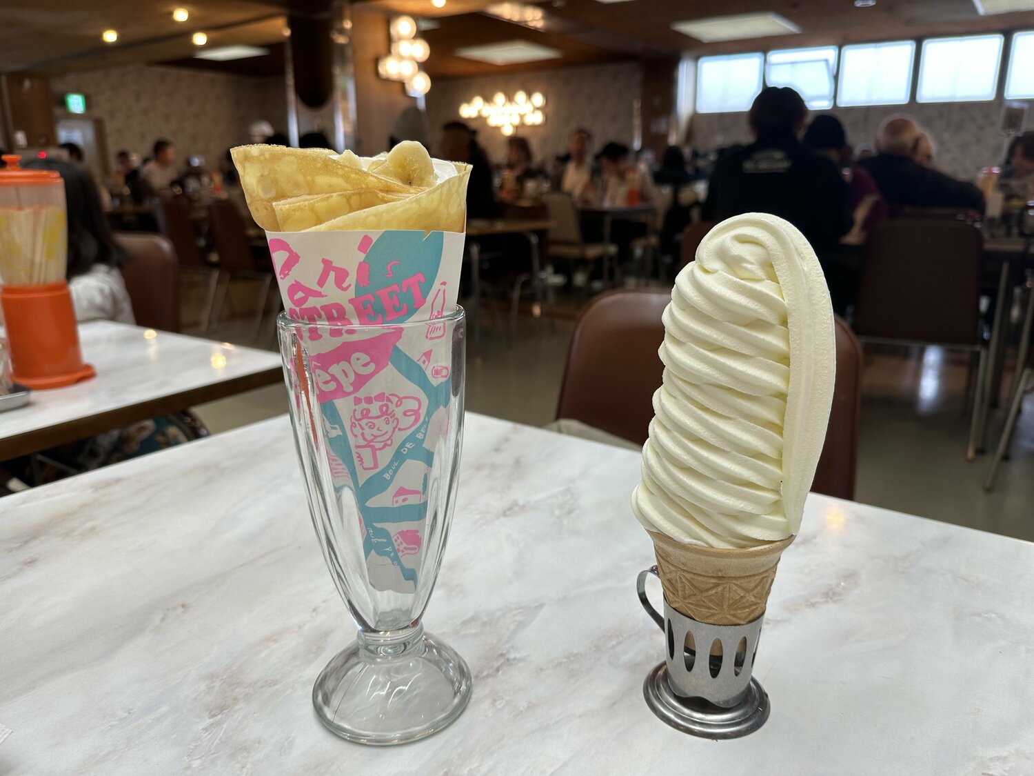 マルカンビル食堂にて。このソフトクリームを箸で食べる。小さめの「ミニソフト」の方を頼む人も多い。クレープはかわいい