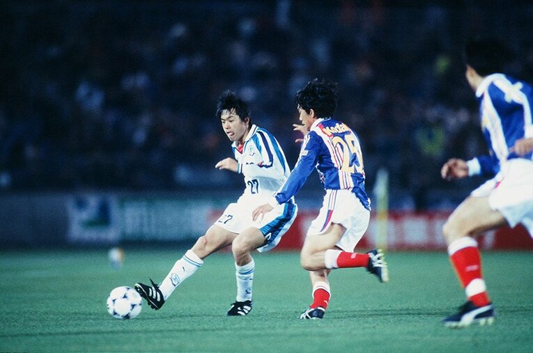 遠藤保仁、デビュー戦の横浜ダービー。中村俊輔とボールを競り合う場面も。 ／ photograph by J.LEAGUE