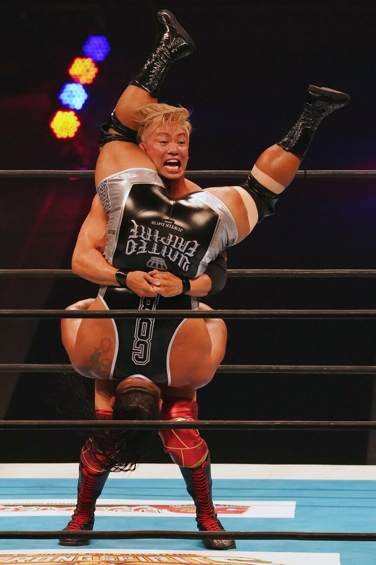 巨体のジェフ・コブを持ち上げてパイルドライバーを狙うオカダ・カズチカ