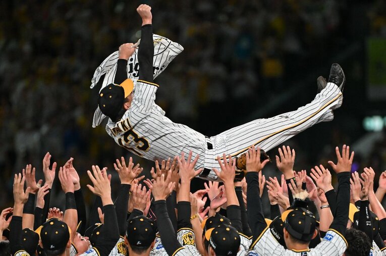 同期入団の横田さんのユニフォームとともに胴上げされた守護神・岩崎 ／ photograph by Hideki Sugiyama
