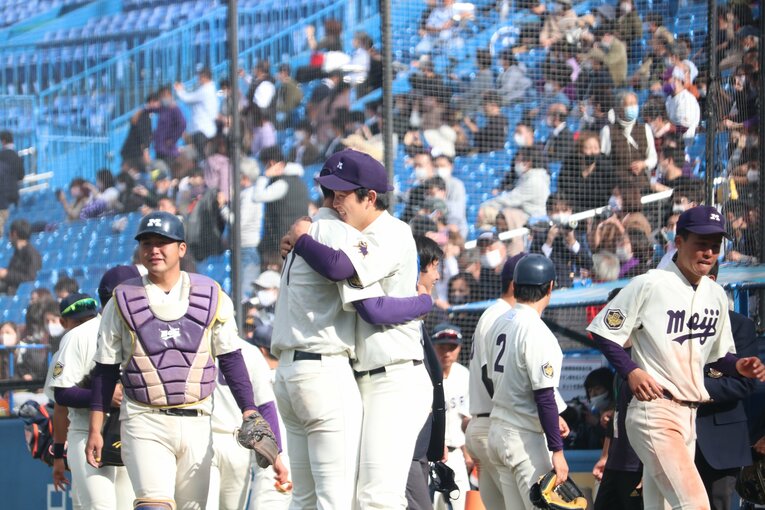 入江大生の明大最後の試合で抱擁を交わす竹田。エースナンバーの11を受け継いだ　©JIJI PRESS