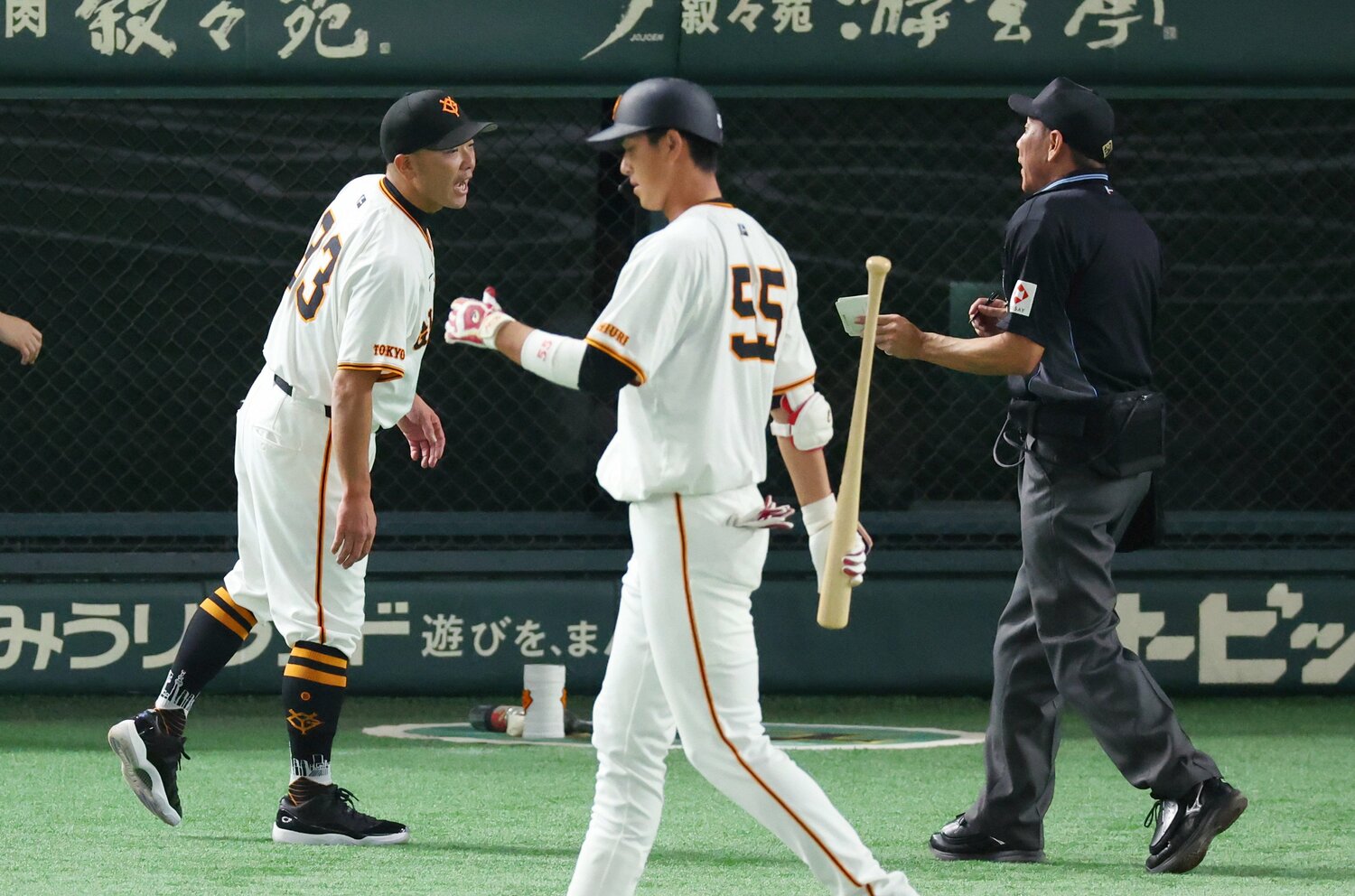 CSファイナル第2戦の７回終わり、選手交代を告げる巨人・阿部監督。手前中央は見逃し三振に倒れた代打の秋広優人　©︎JIJI PRESS