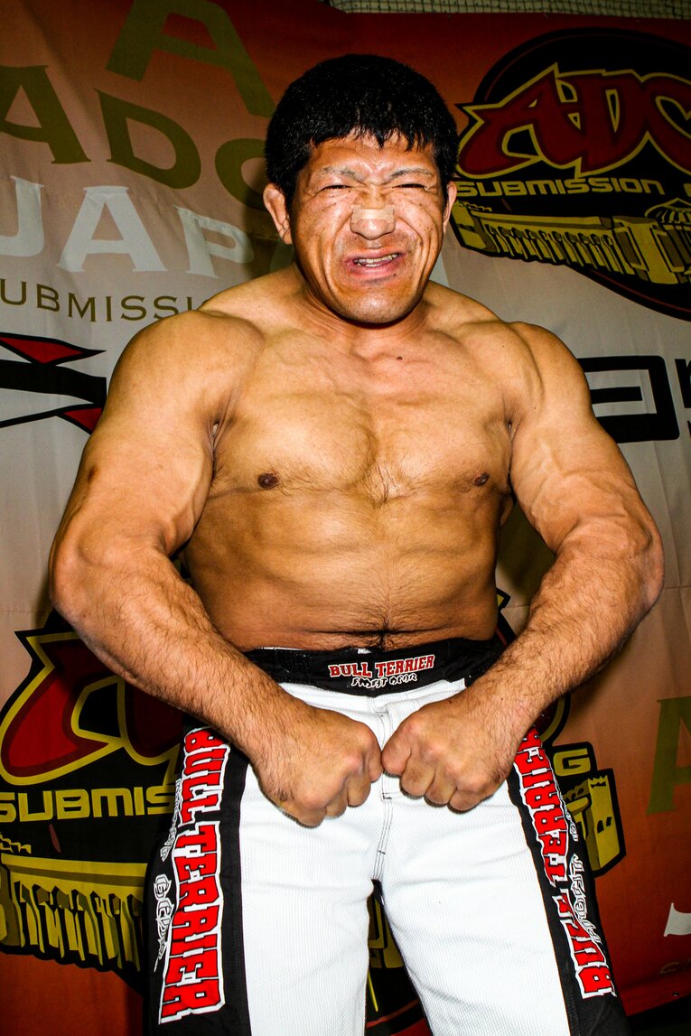 カメラの前で笑顔でポーズを決める関根　©Susumu Nagao