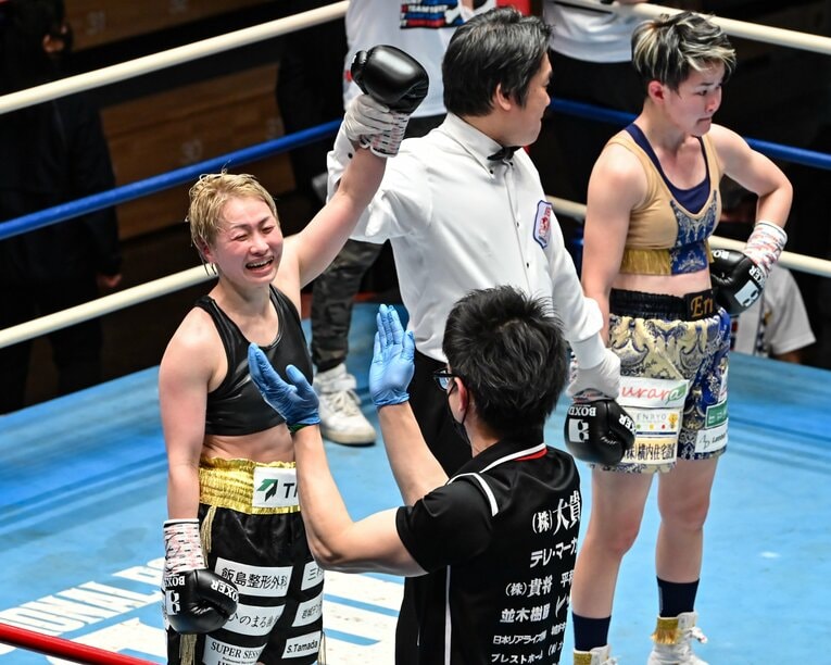 2022年2月、チャンピオンベルトをつかみ取り、トレーナーに喜びの表情を見せる宮尾　©Hiroaki Finito Yamaguchi/AFLO
