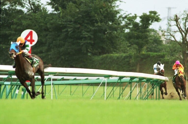 1993年のオールカマーで、舌を出しながら第4コーナーを爆走するツインターボ。後続を完全に置き去りにする衝撃的な大逃げだった ／ photograph by Sankei Shimbun