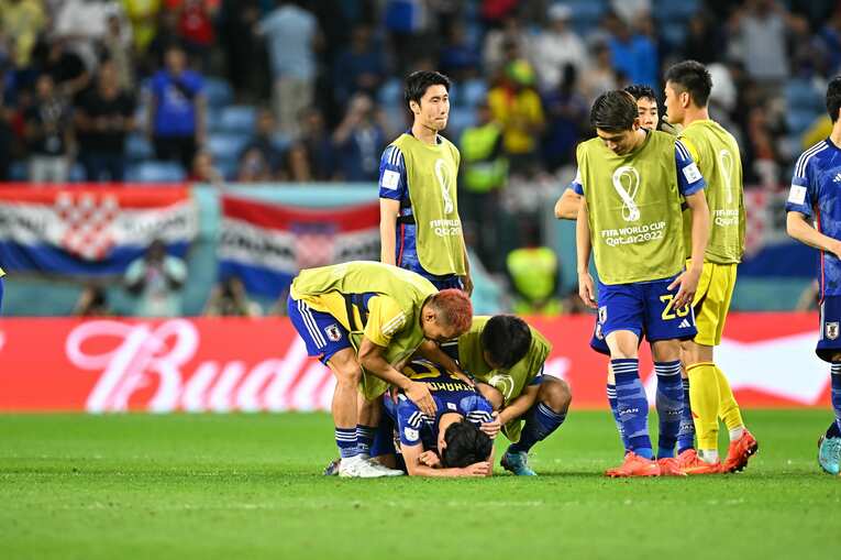 倒れ込む南野に言葉をかける選手たち　©Takuya Kaneko／JMPA