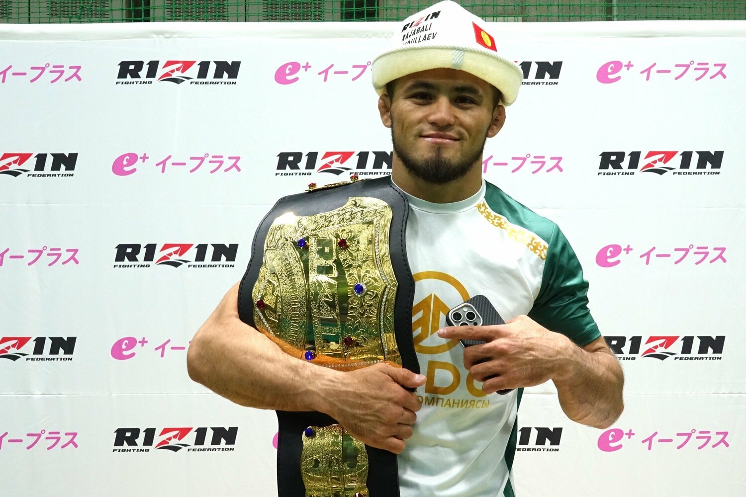 カルパックを被って笑顔でベルトを掲げるシェイドゥラエフ ©Koji Fuse