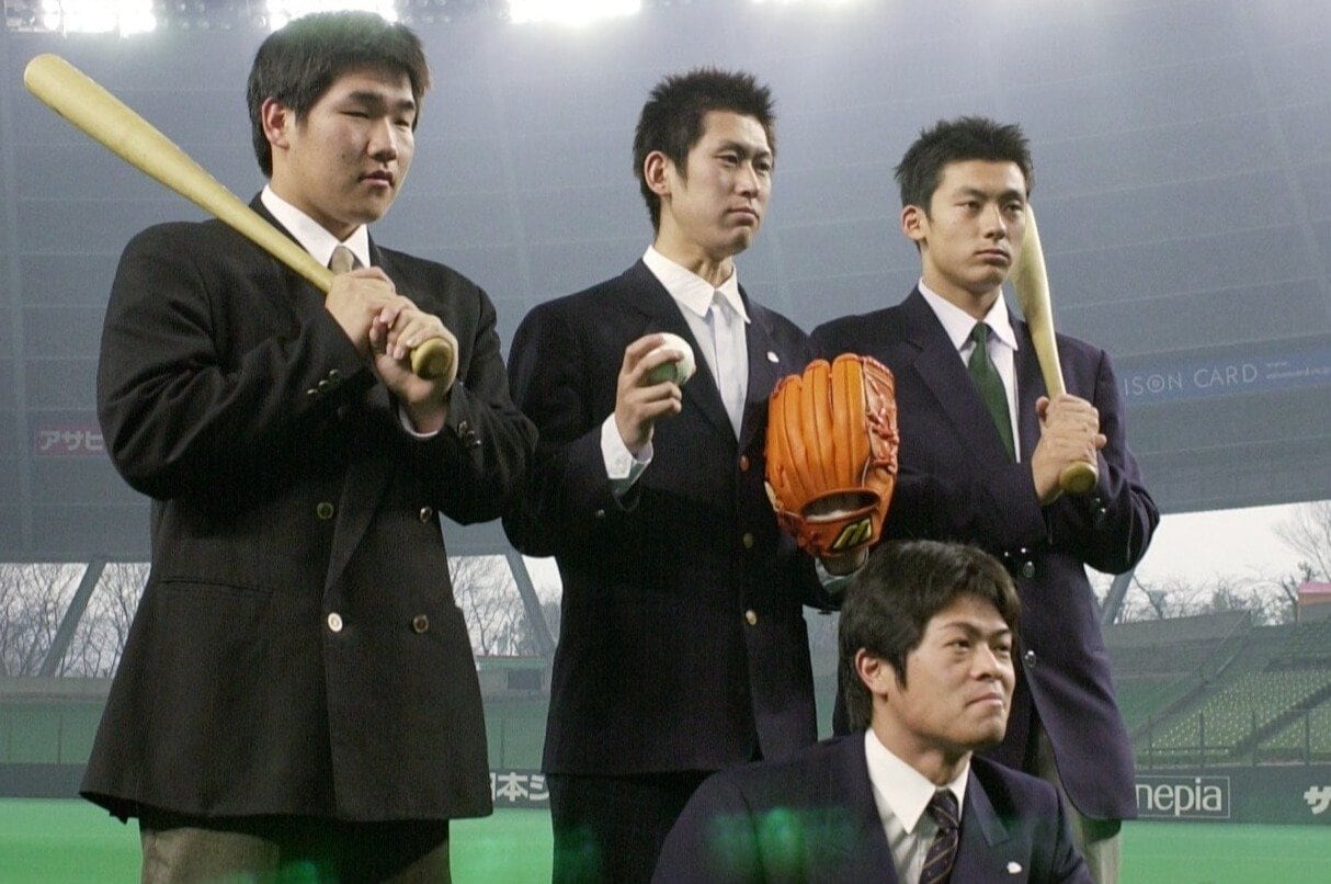 新入団選手発表の会見後、グラウンドでポーズをとる細川亨（中央手前）、後列左から中村剛也、竹内和也、栗山巧　©JIJI PRESS