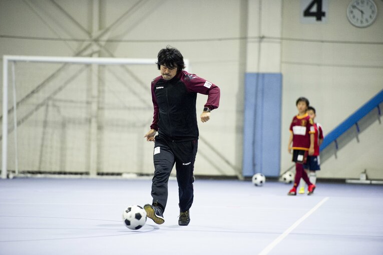 自らもボールを操りながら子どもたちを指導する　©︎Yuki Suenaga