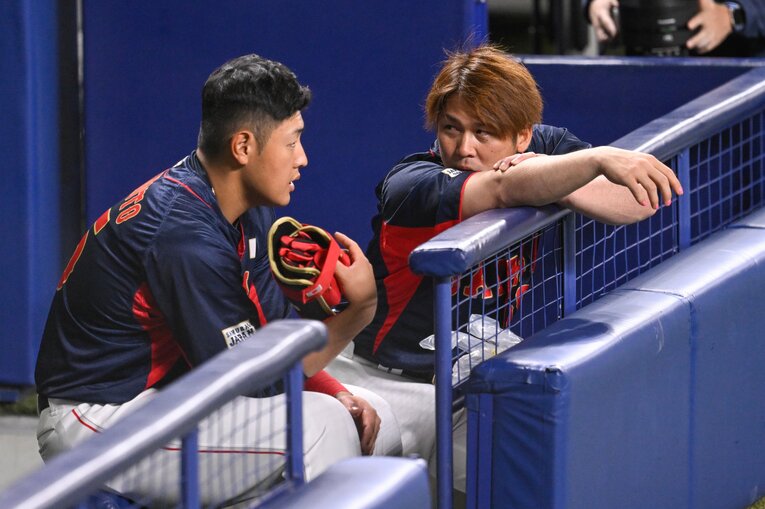 ベンチで話し込む岡本と甲斐　©︎Nanae Suzuki