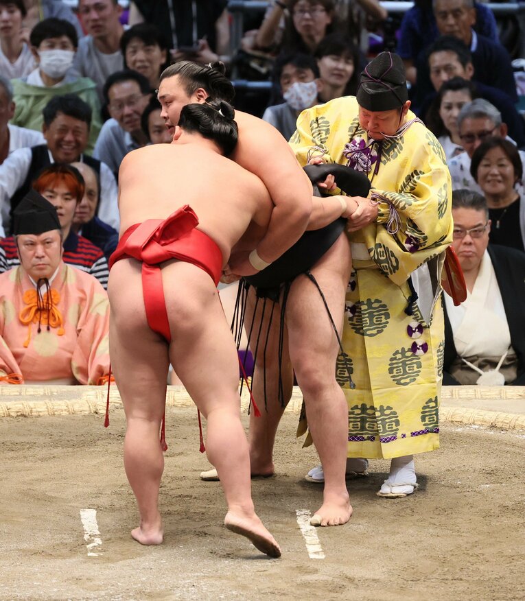 8日目、翠富士（左手前）と霧島の一番は「まわし待った」で一時中断。霧島のまわしを締め直す場面　©JIJI PRESS