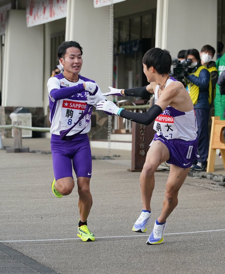 7区の花尾恭輔（当時1年）に襷を渡す花崎　©JIJI PRESS