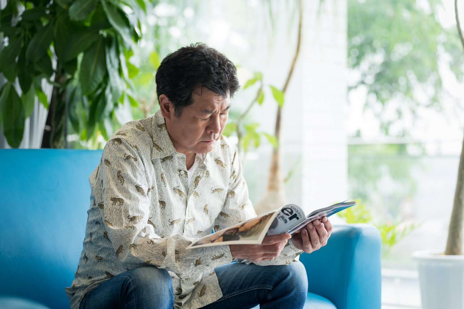 真剣な表情で『Number』井上尚弥号に目を通す赤井英和　©Shiro Miyake