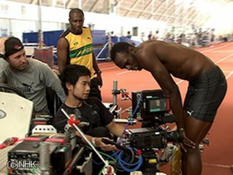 撮影後、モニターに映る自分のフォームを確認するボルト。笑顔を見せるなどリラックスした雰囲気だ。