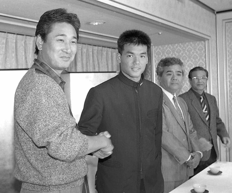 1987年12月、中日入団会見で握手をかわす星野仙一と沖縄水産高校の上原晃　©Okinawa Times/KYODO