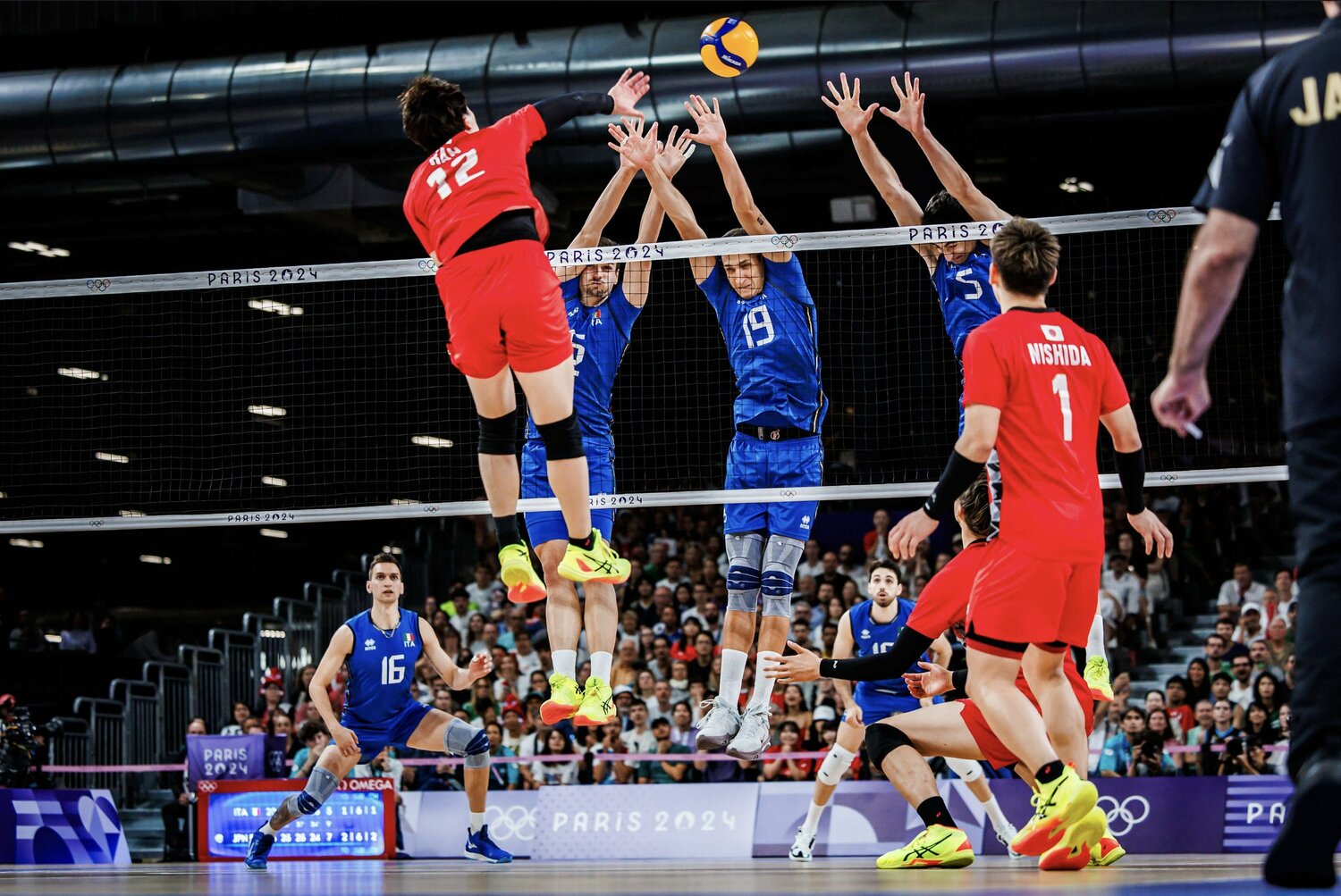 身長207cmのルッソ（19番）らの高いブロックの上からスパイクを打ち込む高橋藍　©︎Volleyball World