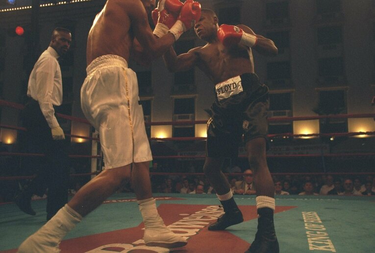 アトランタ五輪後の1996年10月11日、プロデビュー戦の貴重な1枚。メイウェザー（右）はロベルト・アポダカ（メキシコ）相手に2回TKO勝ち　©Getty Images