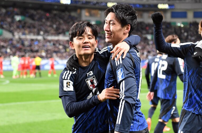 アツいハグをかわす久保と鎌田　©JFA/AFLO